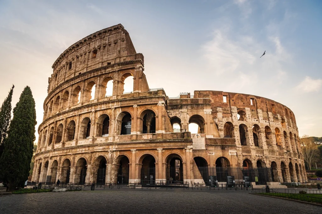 Ancient Roman architecture landmarks including Pantheon and Colosseum at sunset.